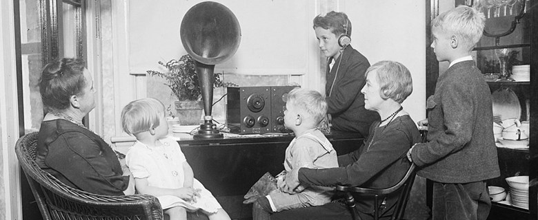 Familj lyssnar på radio förr i tiden. 